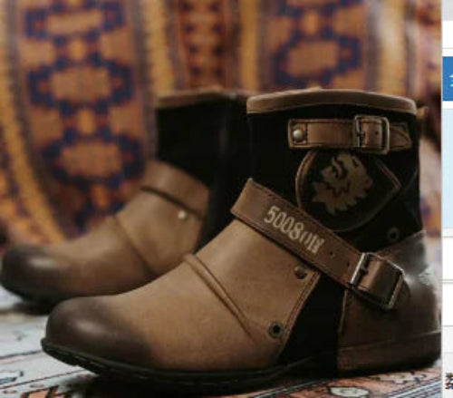 Brown leather boots with decorative elements on a patterned fabric background